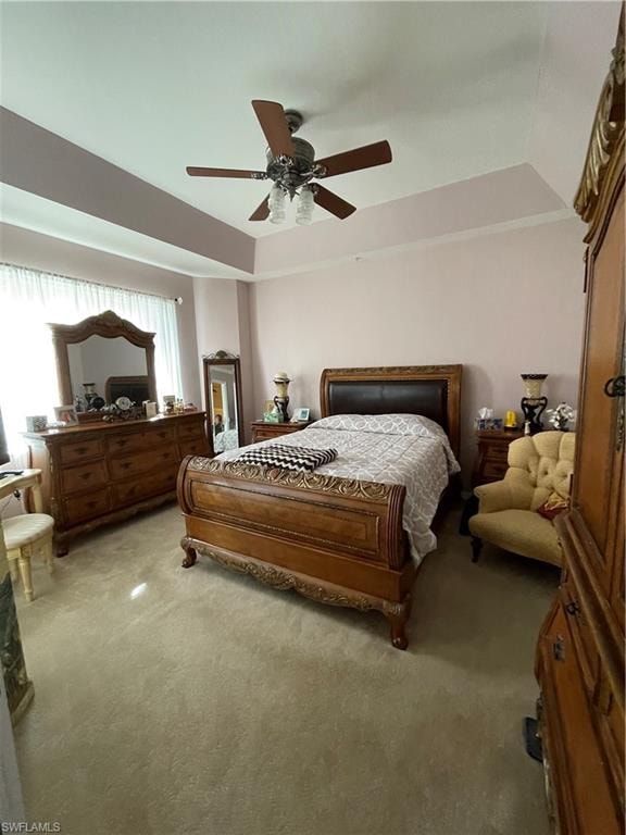 Master Bedroom featuring ceiling fan, light carpet, and lofted ceiling