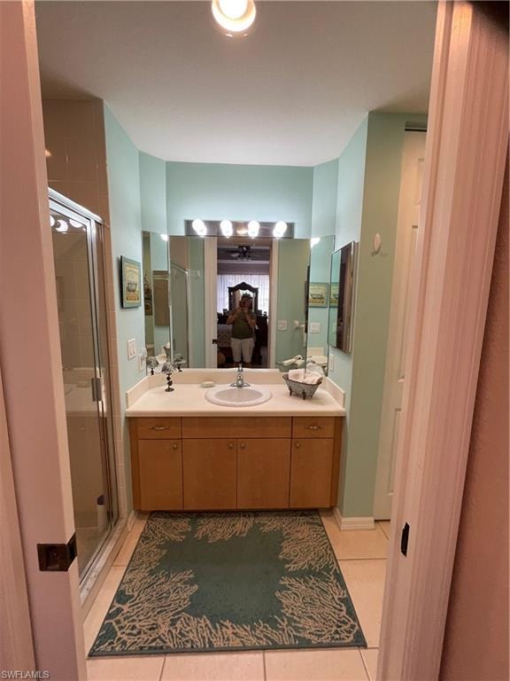 Master Bathroom with vanity, an enclosed shower, and tile patterned flooring