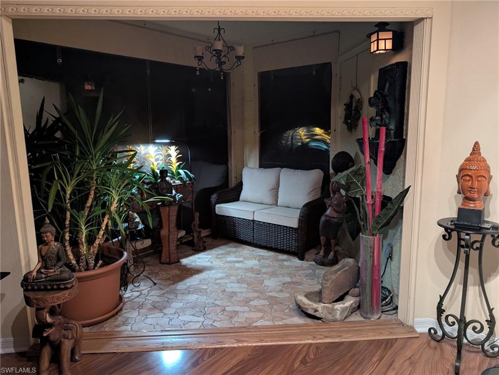Living area featuring a chandelier and wood finished floors