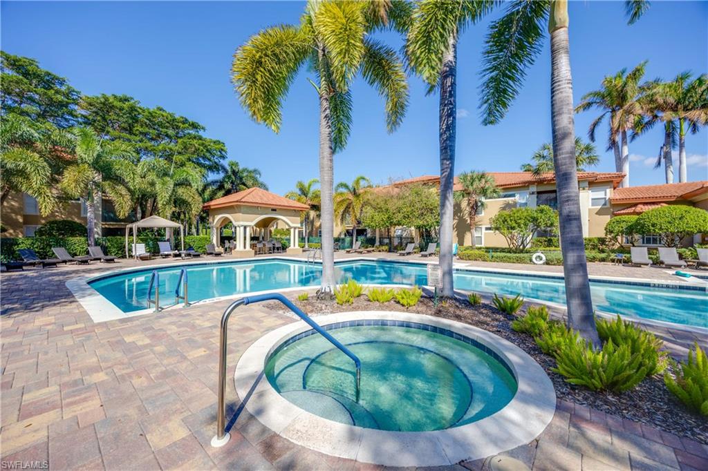 View of pool with a hot tub and a patio