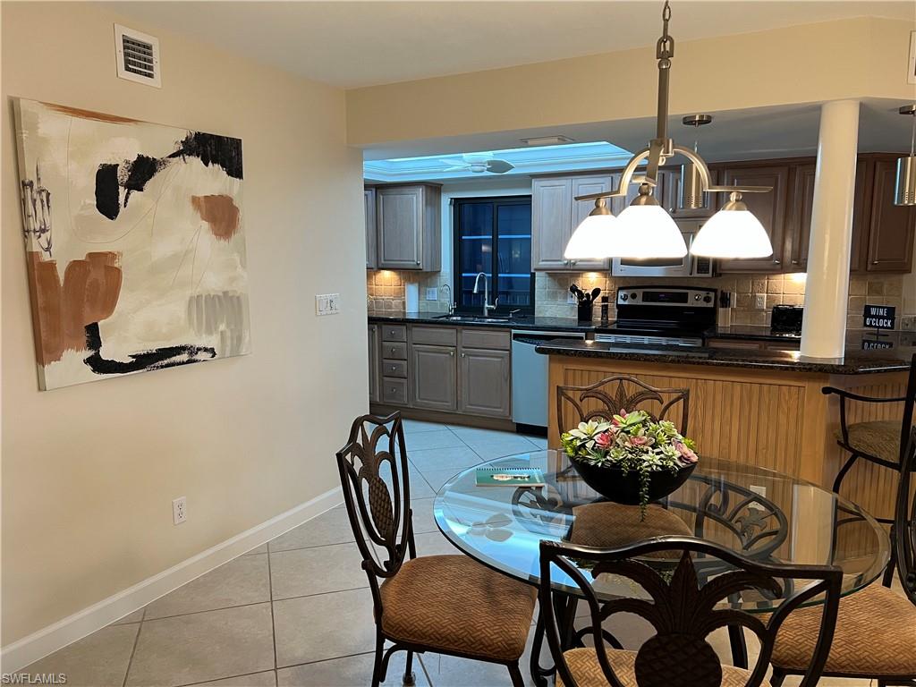 Tiled dining space featuring sink