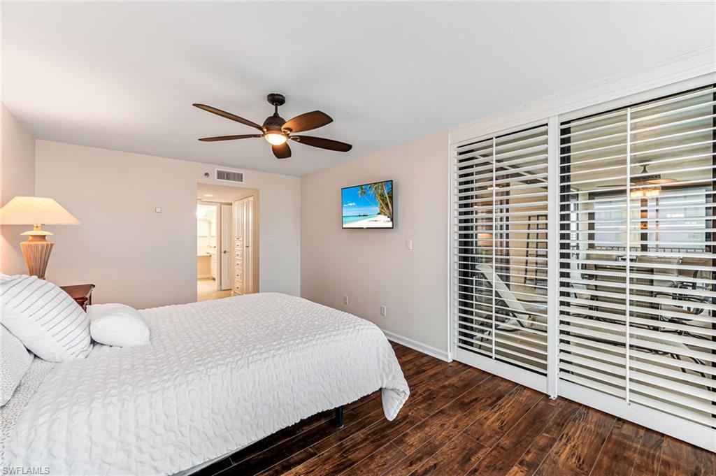 Bedroom with dark wood-type flooring and ceiling fan