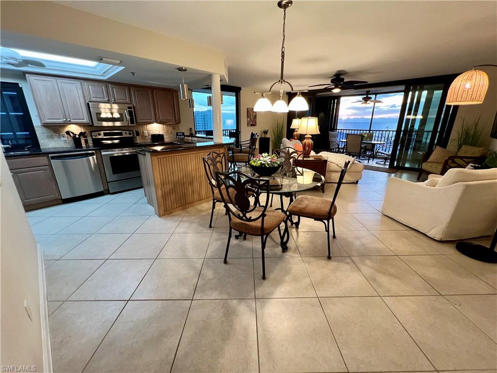 Dining room with ceiling fan and light tile patterned floors