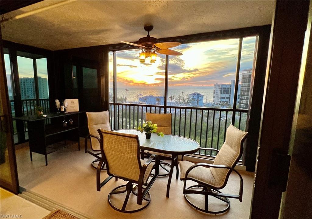 Sunroom / solarium featuring ceiling fan