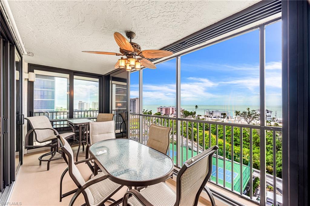 Sunroom / solarium featuring a water view and ceiling fan