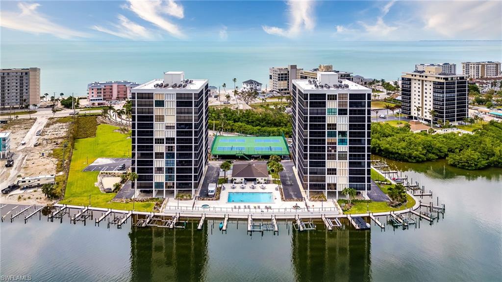 Birds eye view of property with a water view
