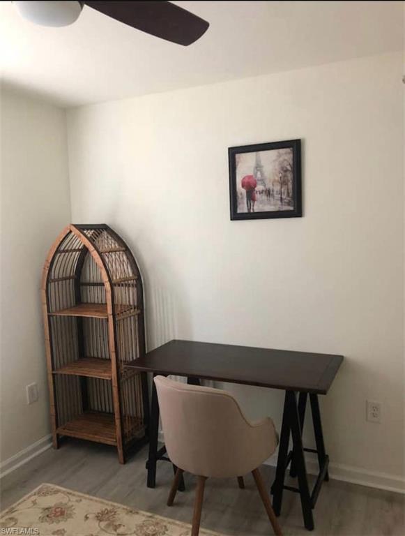 Home office featuring ceiling fan and wood-type flooring
