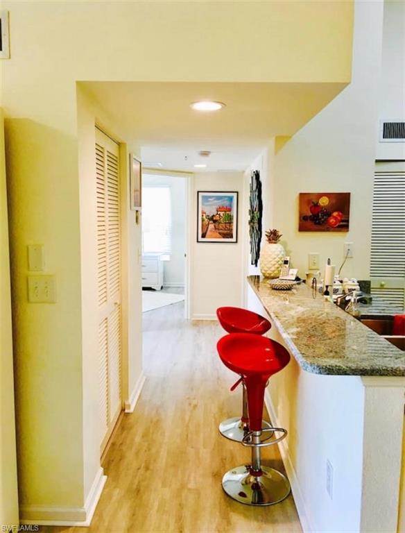 Corridor with light hardwood / wood-style floors