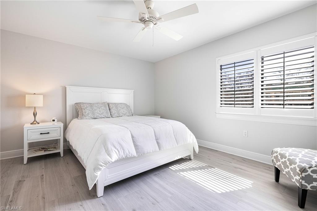 Bedroom featuring ceiling fan and light hardwood / wood-style flooring