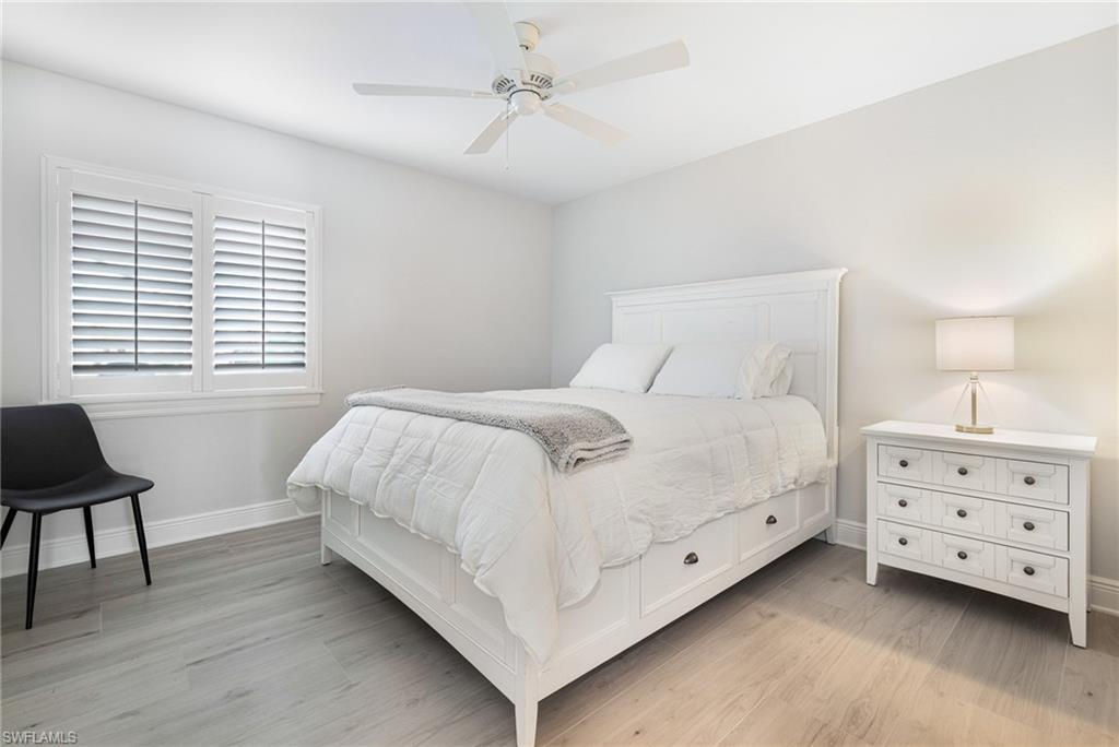 Bedroom with light hardwood / wood-style flooring and ceiling fan