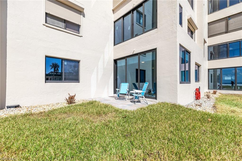 Back of property featuring a yard and a patio area