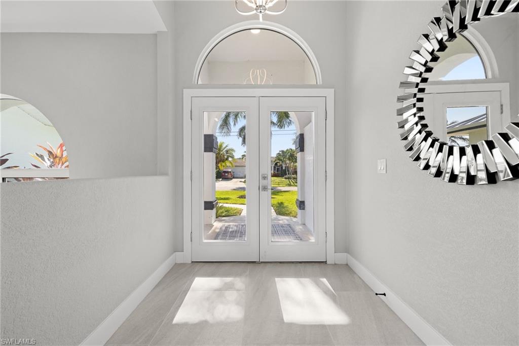 Double-door entry with arched transom and sidelights