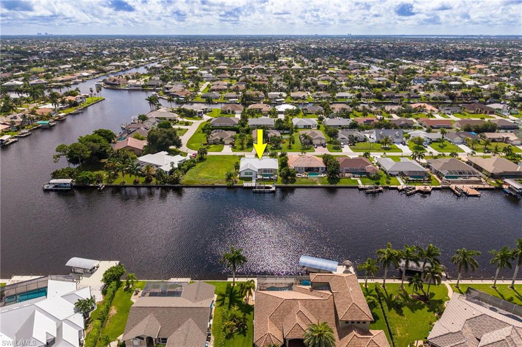 Waterfront property with direct access, featuring a private boat dock, and a spacious lot