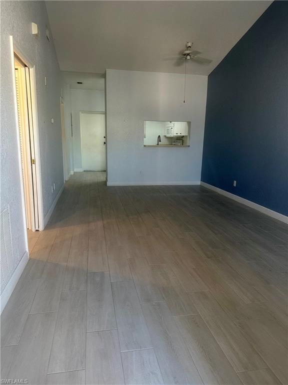Unfurnished living room with light hardwood / wood-style floors and ceiling fan