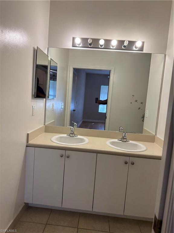 Bathroom featuring vanity and tile patterned flooring