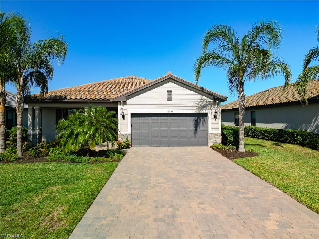 View of front facade with a garage and a front lawn