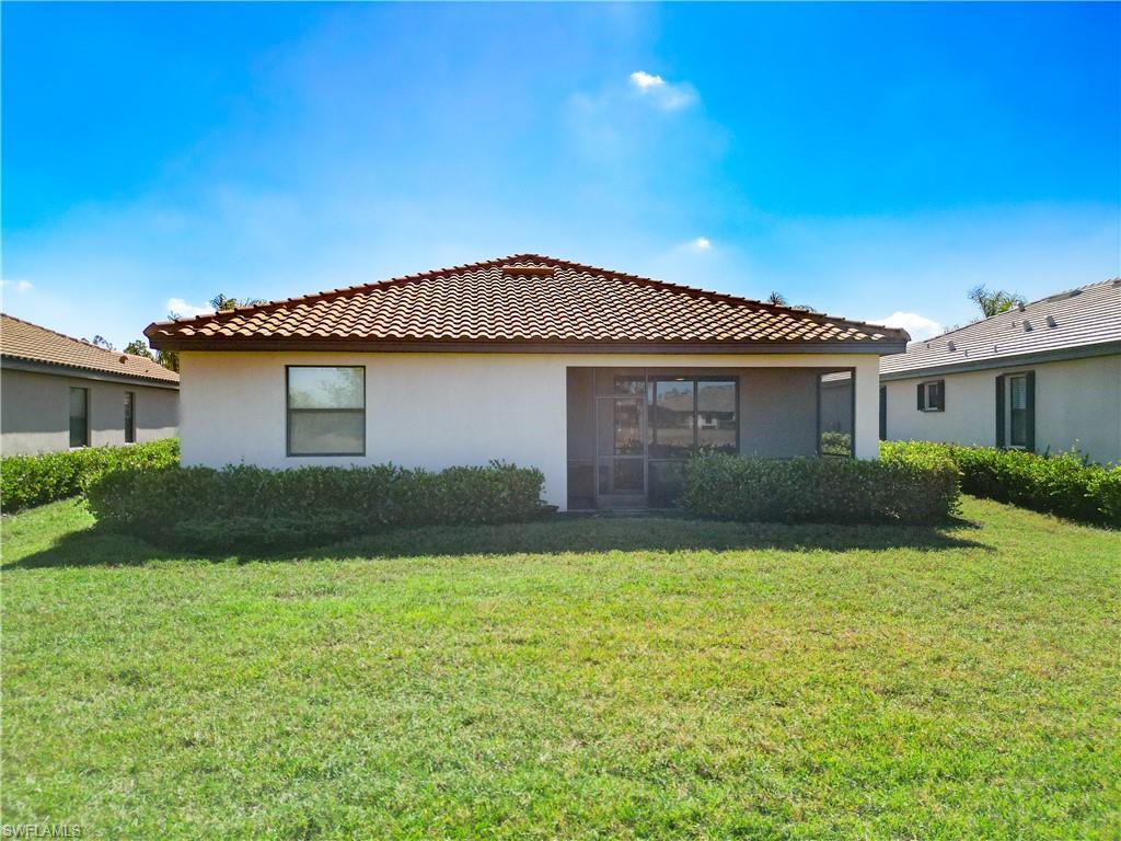 Rear view of house featuring a lawn