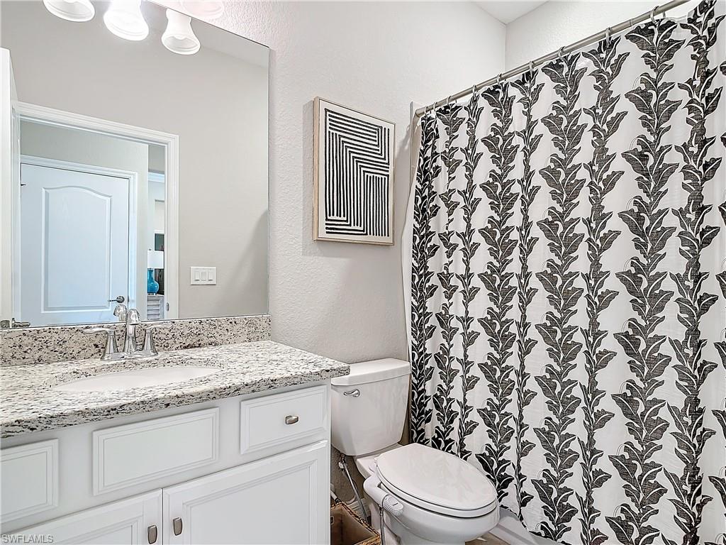 Bathroom featuring vanity and toilet