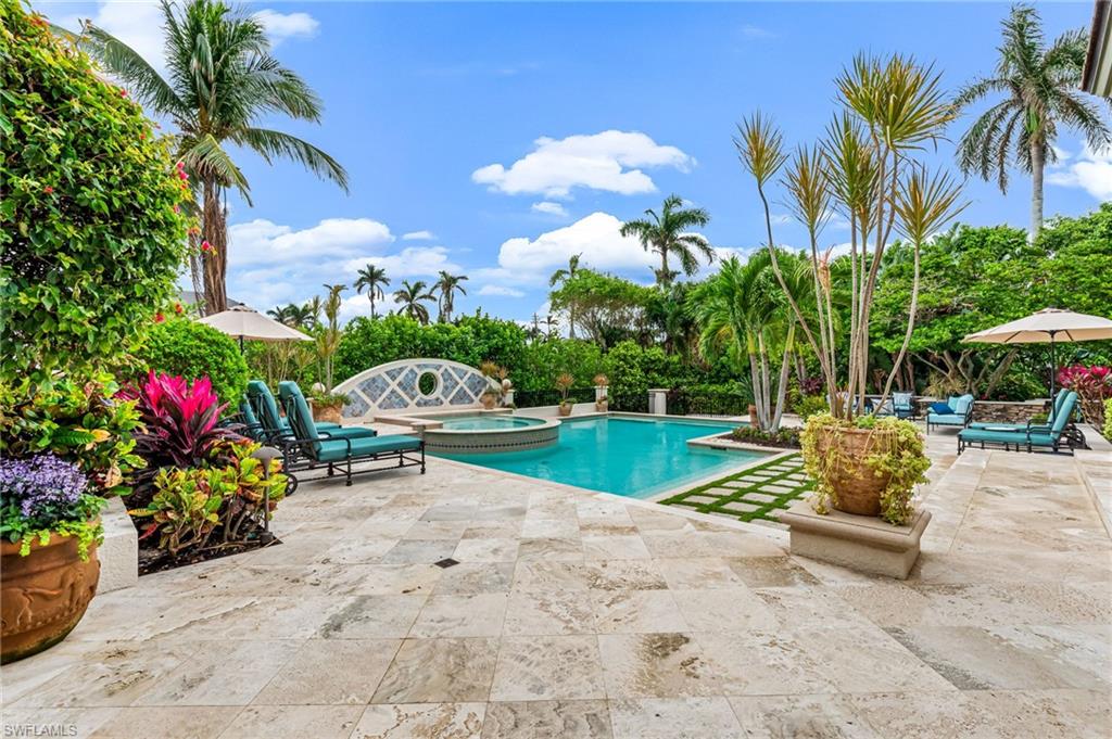 View of pool featuring an in ground hot tub and a patio