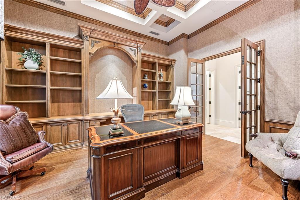Office featuring french doors, ornamental molding, coffered ceiling, light hardwood / wood-style flooring, and beamed ceiling