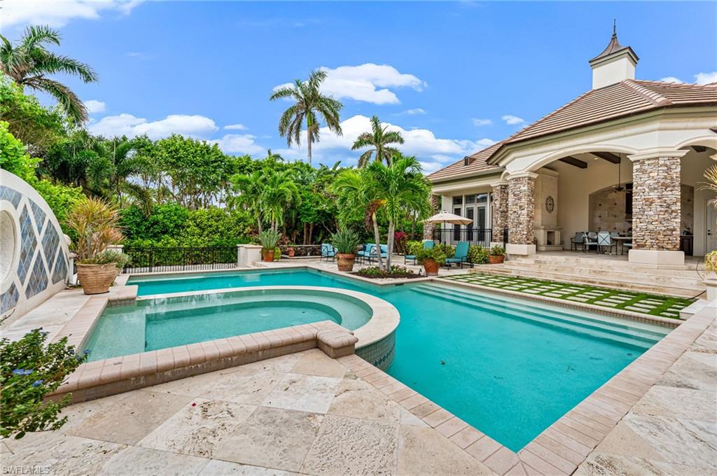 View of swimming pool featuring a patio area and an in ground hot tub