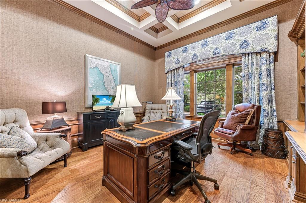 Office featuring ceiling fan, ornamental molding, coffered ceiling, and light wood-type flooring