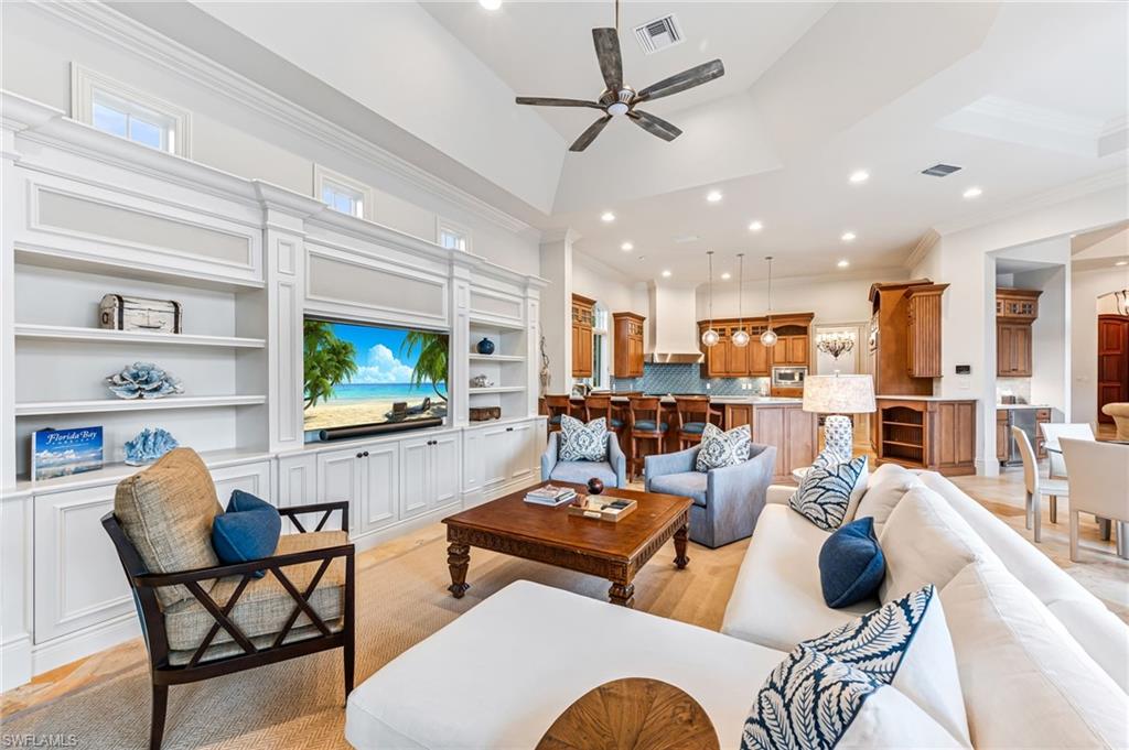 Living room featuring ceiling fan, light hardwood / wood-style floors, and ornamental molding
