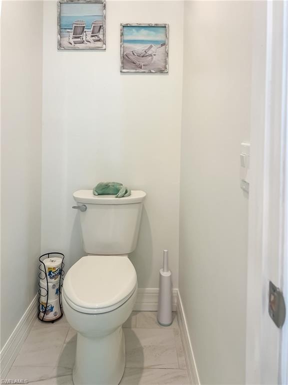 Bedroom featuring connected bathroom, light colored carpet, and ceiling fan