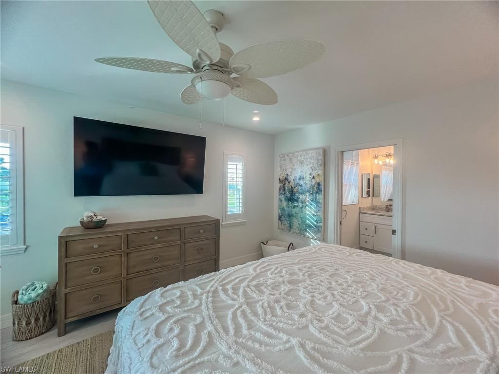 Bedroom featuring light colored carpet and ceiling fan