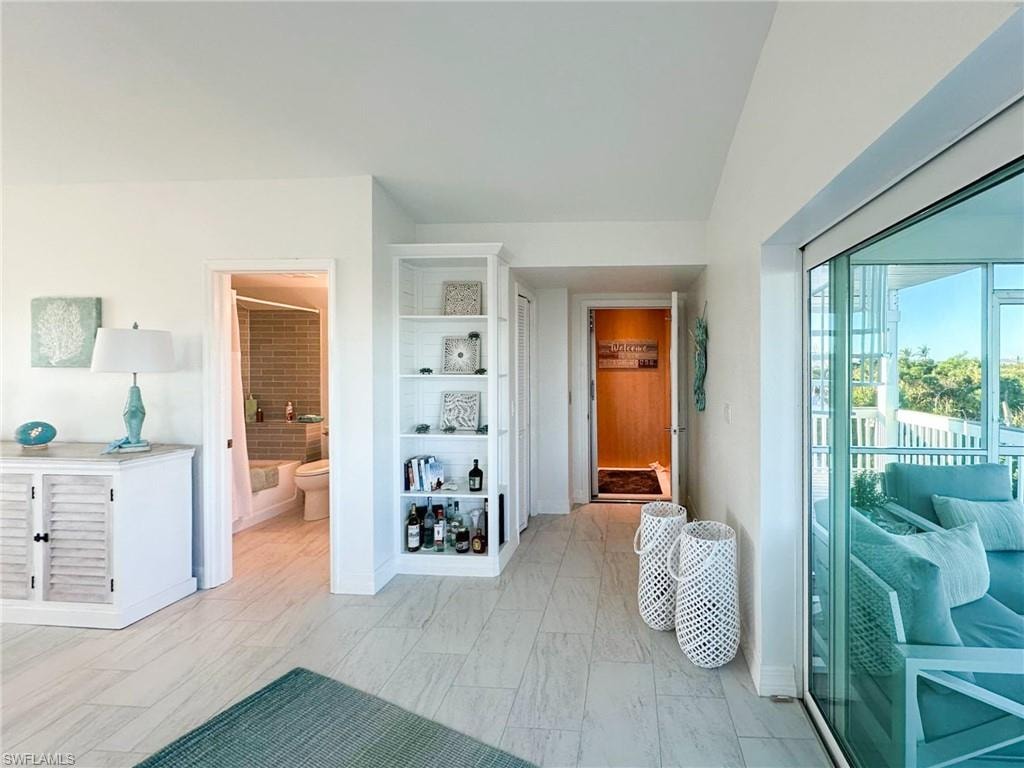 Carpeted bedroom with multiple windows and ceiling fan