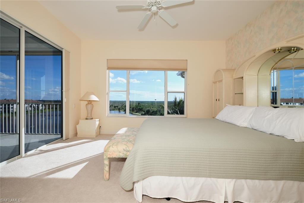 Bedroom with access to outside, ceiling fan, and carpet floors