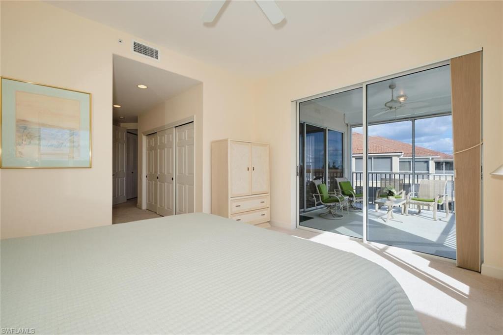 Carpeted bedroom with access to outside, ceiling fan, and a closet