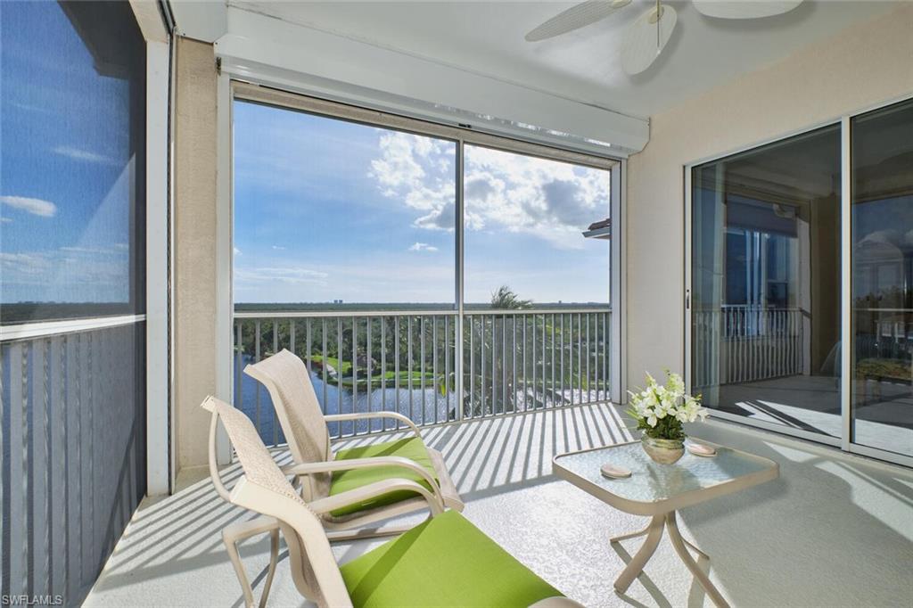 Sunroom with a water view and ceiling fan