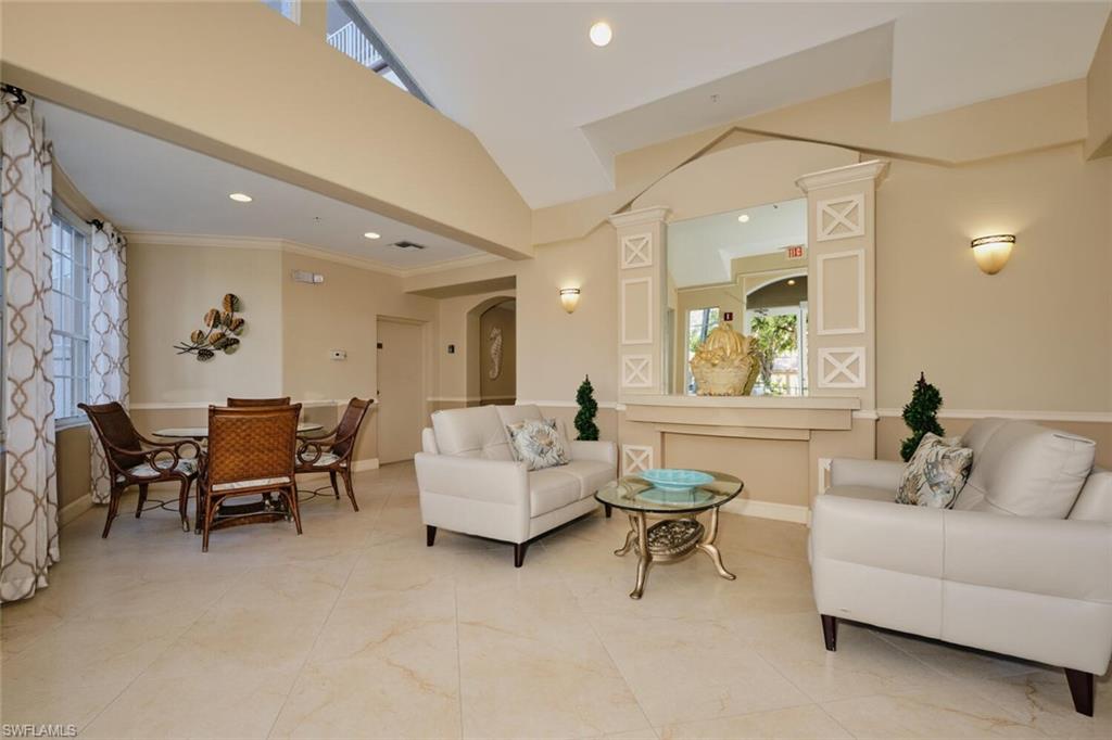 Living room featuring ornate columns, plenty of natural light, and ornamental molding