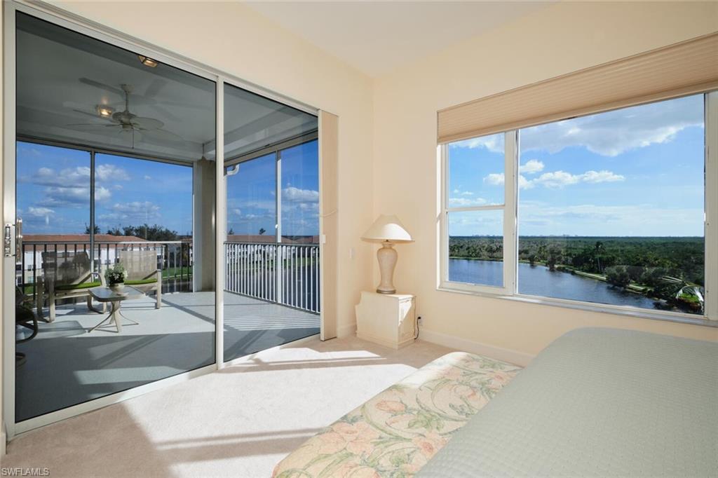 Bedroom with carpet floors and a water view