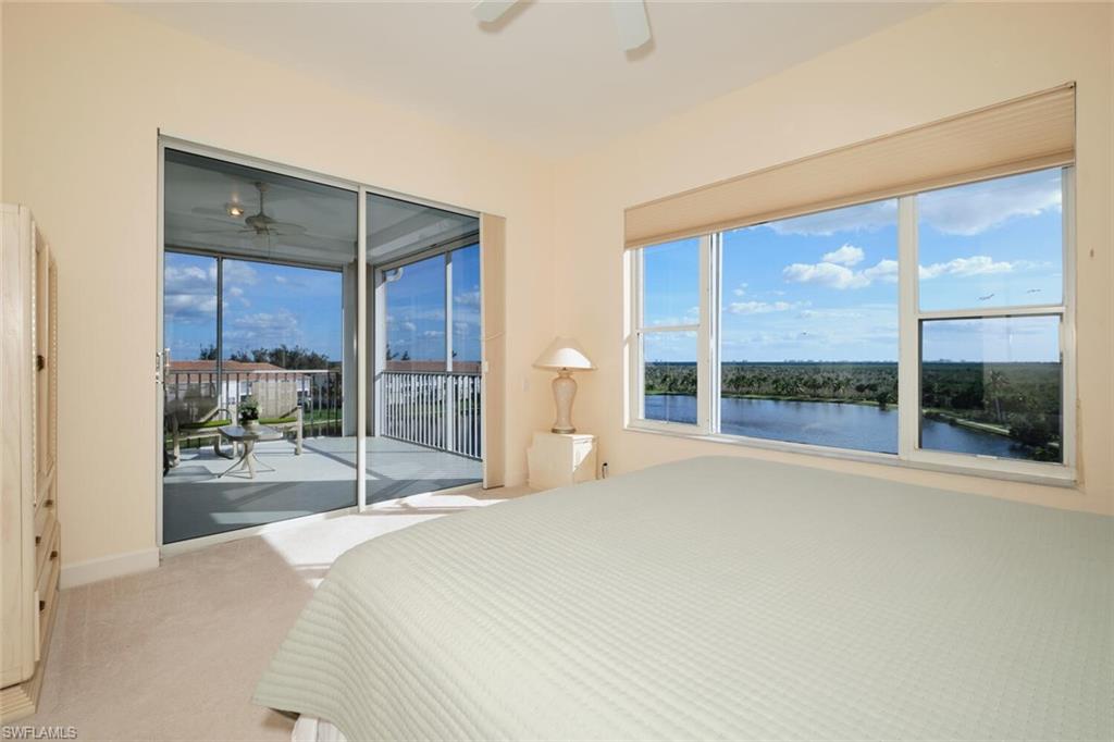 Bedroom with access to outside, a water view, light carpet, and ceiling fan
