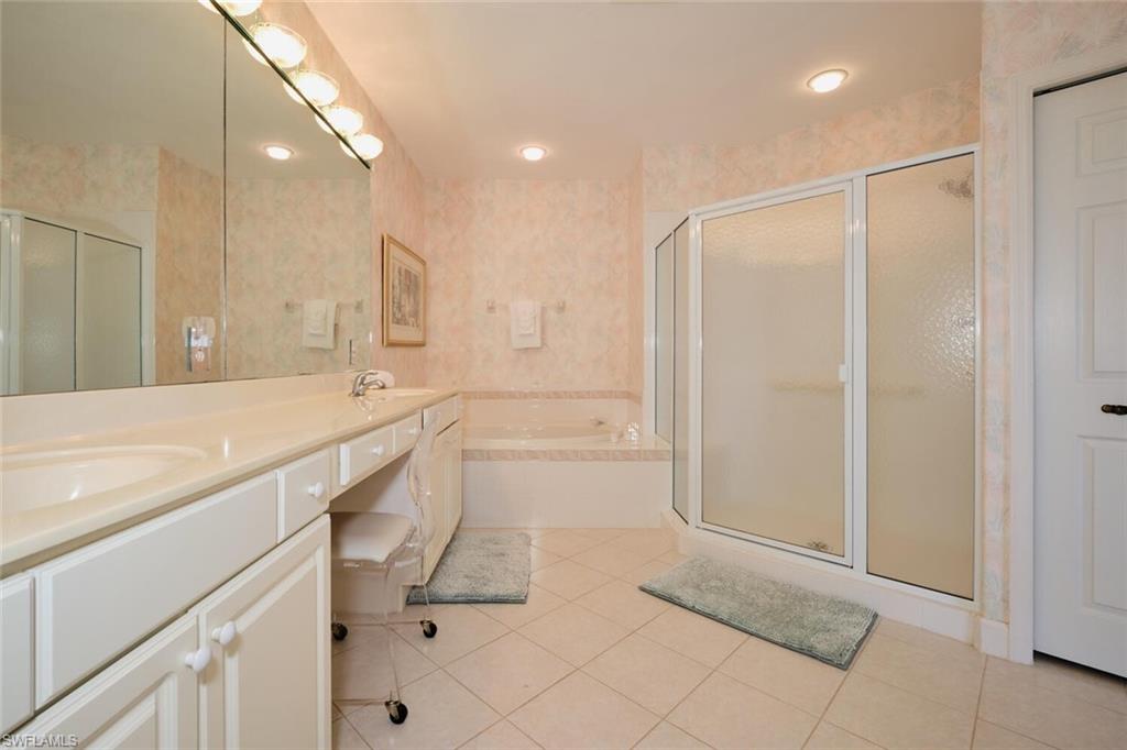 Bathroom with vanity, tile patterned floors, and independent shower and bath