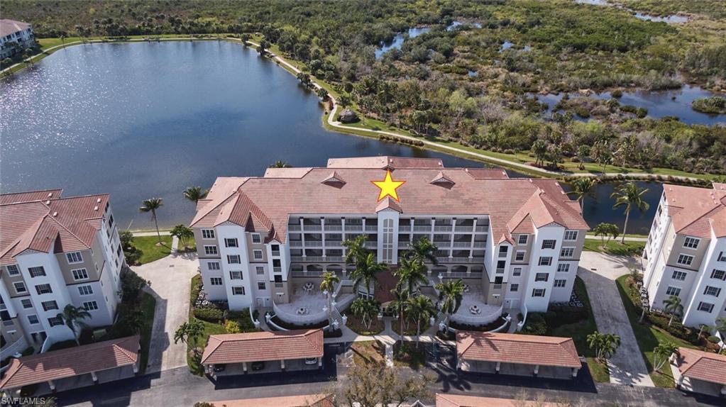Birds eye view of property with a water view