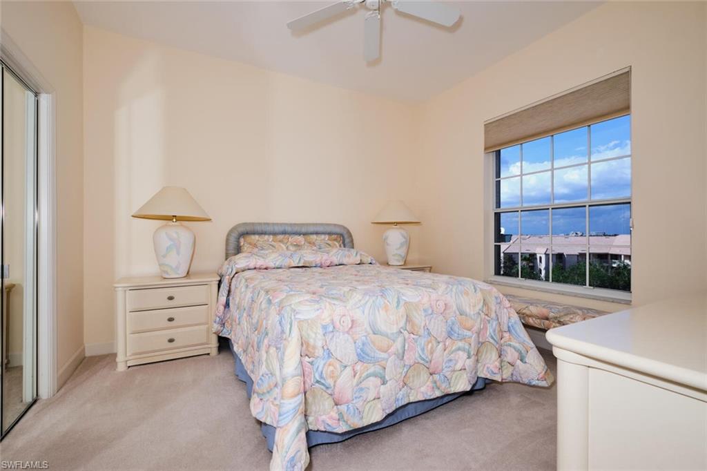 Carpeted bedroom with a closet and ceiling fan