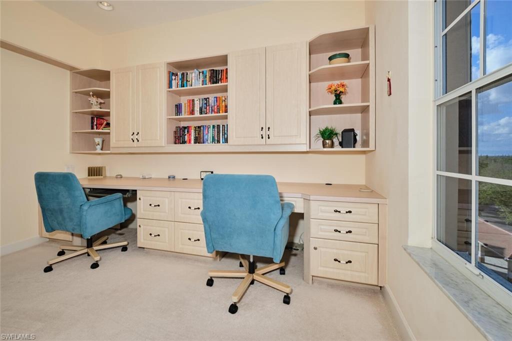 Carpeted office featuring built in desk