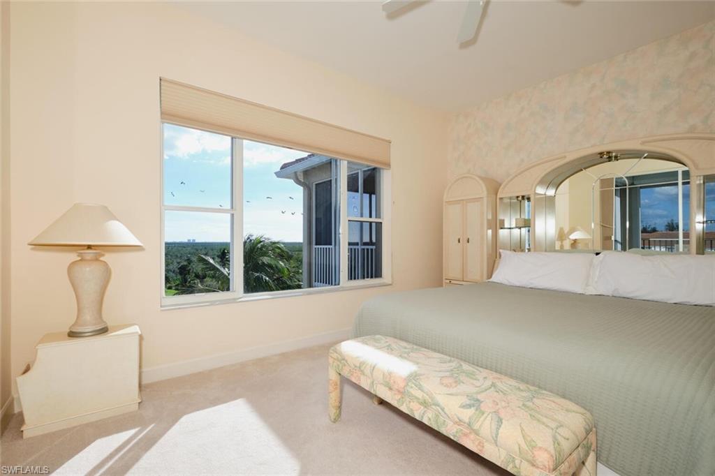 Bedroom with light colored carpet and ceiling fan