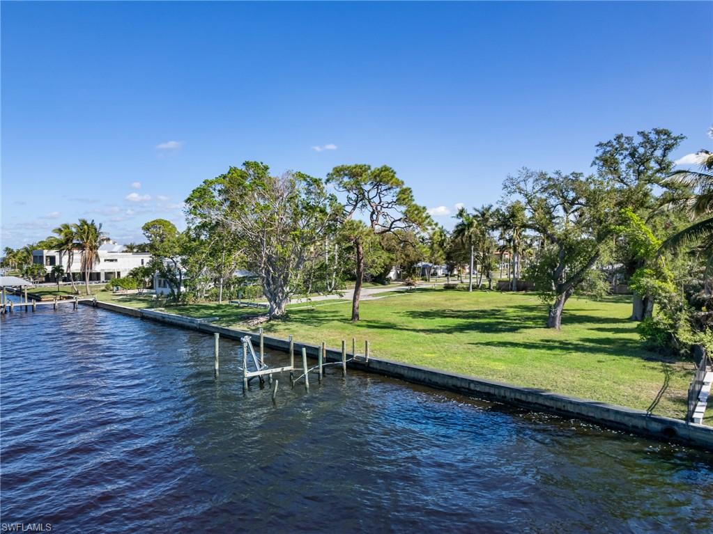 Dock area featuring a yard and a water view
