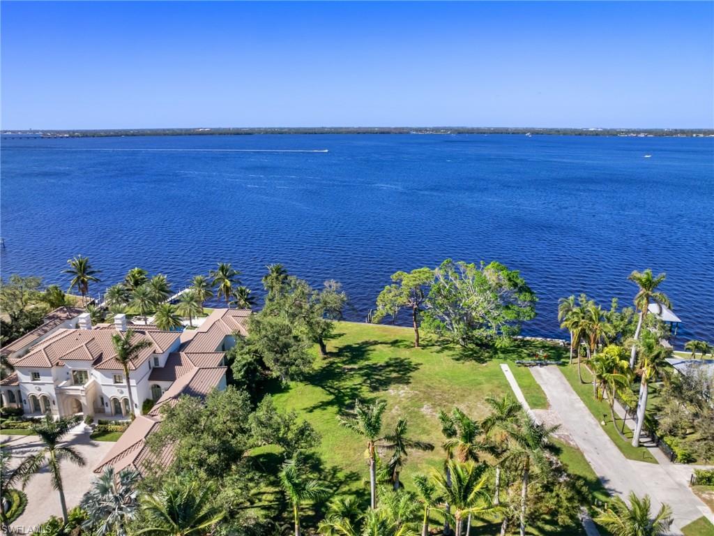 Birds eye view of property with a water view