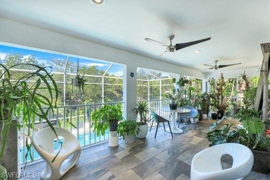 Sunroom / solarium featuring ceiling fan