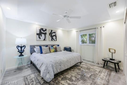 Bedroom with ceiling fan and hardwood / wood-style floors