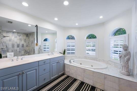 Bathroom with vanity and independent shower and bath