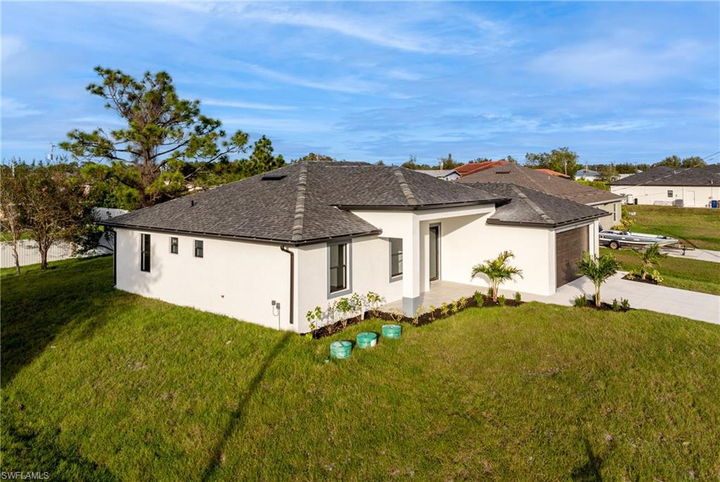 Ranch-style home with a garage and a front lawn