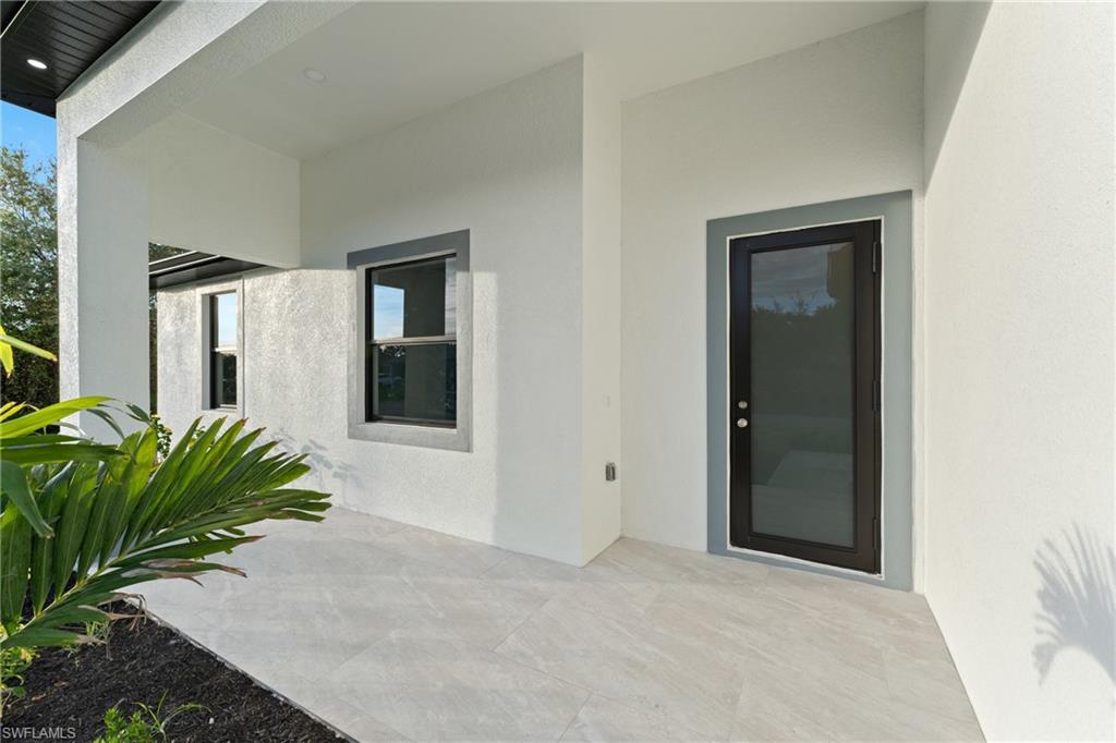 Property entrance with a patio