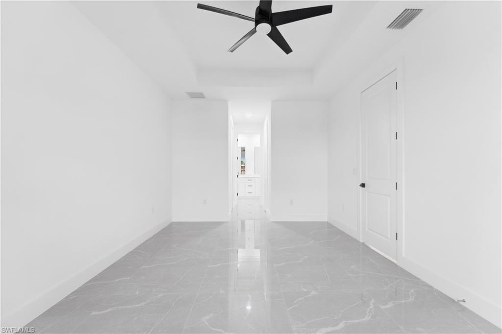 Unfurnished room featuring ceiling fan
