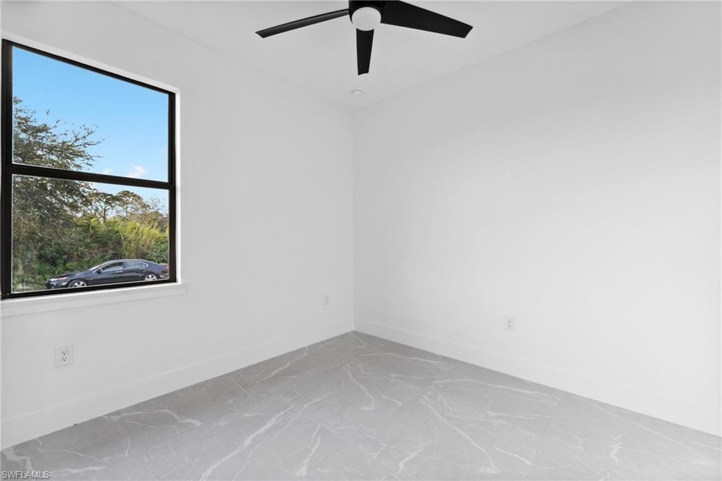 Empty room with plenty of natural light and ceiling fan